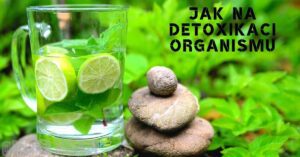 a glass of infused water with lime and mint leaves on a natural stone stack, promoting natural detoxification and healthy lifestyle.