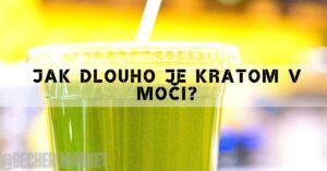 a green drink in a plastic cup with a straw, set against a blurred background with warm lighting.