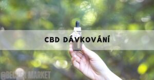 a hand holding a CBD oil dropper bottle for optimal dávkování against a blurred green background