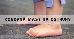 a bare foot with visible heel pain or patní ostruhy, standing on a rough surface near water.