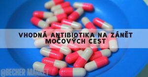 a close-up of red and white capsule-shaped antibiotics commonly used for treating zánět močových cest in a blue container