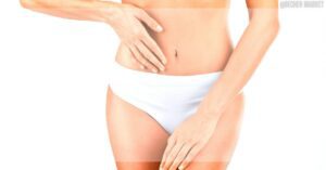 a person holding their abdomen to illustrate digestive comfort or discomfort related to gut health